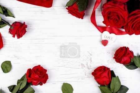Congratulatory festive background for Valentine's day, birthday,mother's day with a hearts, red roses on a white wooden background. Greeting invitation card, mockup