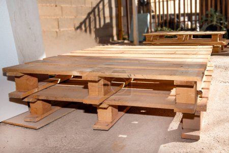 Wooden supports for moving and transporting goods. Warehouse pallet for moving goods. Paleta, Estiba or tarima in the factory territory