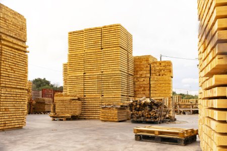 Freshly sawn boards, stacked on top of each other, Pallets On the territory of the woodworking factory of the plant. Industrial wood processing, production of pallets for cargo transportation