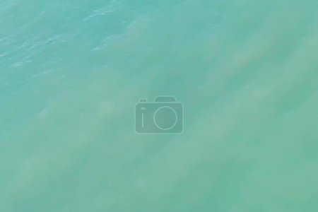 Background from the surface of calm sea water of the Mediterranean sea in Turquoise colored. Color background of halftones with soft transitions of sea green color