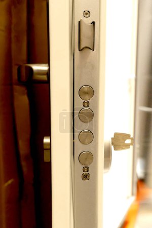 Close-up of door lock parts, bolts, handle, inserted key, end view. Presentation of furniture and fittings on a store window. 