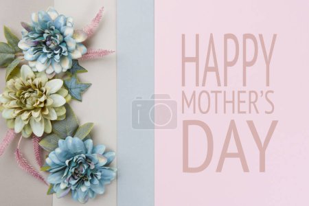 Foto de Happy Mother's Day Pastel Blue and Pink Colored Background. Flat lay floral greeting card with beautiful silk flowers. - Imagen libre de derechos