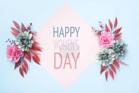 Foto de Happy Women's Day Pastel Blue and Pink Colored Background. Flat lay floral greeting card with beautiful silk flowers. - Imagen libre de derechos