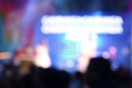 Captured in motion, a crowd of concert-goers is seen in very blur of colorful lights and energy