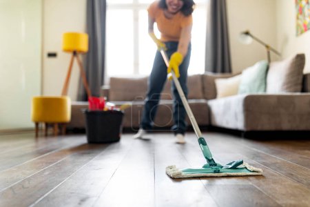 Photo for Smiling Young Woman Washing Floor In Living Room With Mop, Happy Millennial Female Making Spring-Cleaning At Home, Mopping Dirty Surface With Detergents, Enjoying Domestic Chores, Selective Focus - Royalty Free Image