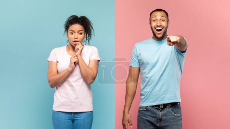 Photo for Shocked black couple gaze straightly at camera with bated breath, happy man pointing at something, standing over pink and blue background, impressed woman looking with excitement - Royalty Free Image