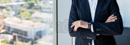 Photo for Unrecognizable confident mature businessman with folded arms standing in office interior near window, panorama with free copy space. Career concept - Royalty Free Image