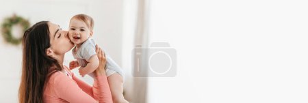 Téléchargez les photos : Family Offer. Wide Banner With Happy Mother Kissing Her Adorable Baby, Extended Horizontal Shot Of Loving Young Mom Bonding With Infant Child At Home, Enjoying Motherhood, Panorama With Copy Space - en image libre de droit