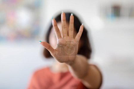 Foto de Unrecognizable Young Woman Covering Her Face With Open Palm, Female Showing Stop Gesture With Hand, Saying No To Violence Or Discrimination, Denying Proposal Or Offer, Selective Focus, Copy Space - Imagen libre de derechos