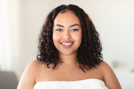 Photo for Portrait of happy beautiful plus size woman with smooth face skin looking at camera and smiling, enjoying result of beauty treatment, bathroom interior, closeup, copy space - Royalty Free Image