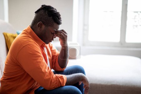 Photo for Side view of upset stressed young chubby african american man dealing with strong headache, exhausted black guy feeling frustrated depressed tired touching nose bridge, close up, copy space - Royalty Free Image