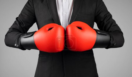 Photo for Cropped Shot Of Young Businessman Wearing Boxing Gloves And Suit, Motivated Unrecognizable Male Entrepreneur Ready For Kick, Standing Isolated Over Grey Studio Background, Leadership Concept, Closeup - Royalty Free Image