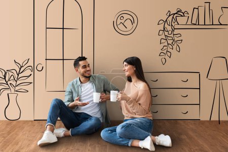 Photo for Loving middle eastern millennial couple sitting on floor at new apartment, drinking tea, having conversation, smiling, living room interior sketch background, collage. Moving, renovation, relocation - Royalty Free Image