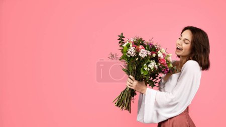 Foto de Feliz inspirada sorprendida joven europea disfrutar de ramo de tulipanes blancos, regocijarse vacaciones de primavera aislado sobre fondo rosa, panorama, estudio. Regalo en fecha, cumpleaños, felicitación, anuncio y oferta - Imagen libre de derechos