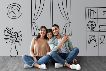 Photo for Happy middle eastern family father, mother and little daughter sitting on floor over cozy living room interior sketch and embracing, posing at new house, collage for real estate, mortgage concept - Royalty Free Image