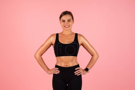 Photo for Body Shaping Concept. Smiling Young Woman In Sportswear Posing On Pink Studio Background, Beautiful Sporty Female Enjoying Her Fit Shape After Weight Loss And Fitness Trainings, Copy Space - Royalty Free Image