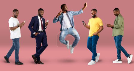 Foto de Cheerful young black men in casual, suit typing on smartphones, jumping, take selfie, isolated on pink background, studio, panorama. Lifestyle online, win, technology for social networks, app for blog - Imagen libre de derechos
