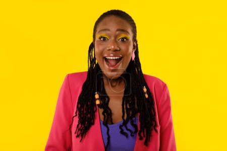 Photo for Black Lady Shouting Wow In Excitement Looking At Camera Posing Standing On Yellow Studio Background. Portrait Of Excited Female With Bright Makeup. Great Offer Advertisement Concept - Royalty Free Image