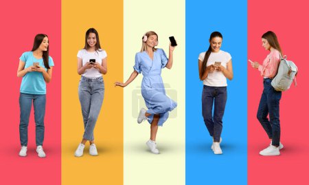 Photo for Smiling young european women in casual, headphones typing on smartphone, isolated on colorful background, studio, panorama. Music and fun, lifestyle, communication online, tech for social networks - Royalty Free Image