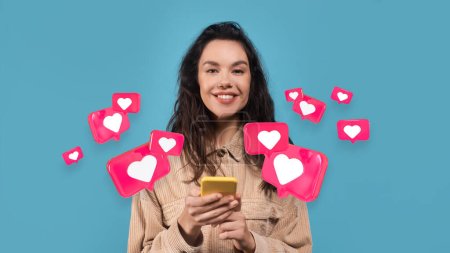 Smiling millennial european female has romantic chat with hearts on smartphone isolated on blue studio background, panorama, collage. Dating remotely, social networks, new app and good love message
