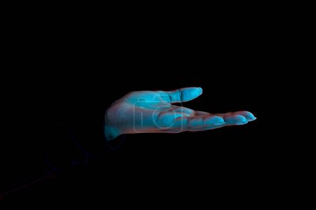 Photo for Close up of female hand with palm up receiving or holding something over black background, free space. Side view of open palm showing something - Royalty Free Image
