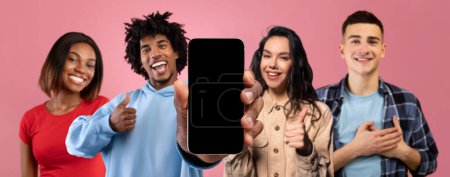 Photo for Win and chat. Glad millennial african american and caucasian people pointing finger at phone with blank screen do thank gesture and thumb up, recommend website, app, isolated on pink background - Royalty Free Image