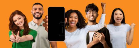 Photo for Happy excited different people show smartphone with empty screen, make victory and success gesture with hand isolated on orange studio background, panorama. Emotion, website, app, ad and offer - Royalty Free Image