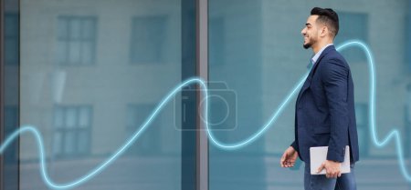 Photo for Smiling successful arab millennial businessman in suit with laptop goes to office building with abstract line, empty space, panorama. Business with gadget for work, new normal, ad and offer - Royalty Free Image