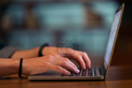 Photo for Unrecognizable man touching with both hands laptop modern pc keyboard, cropped of employee user working online late at night, surfing on Internet, programmer coding, copy space, closeup - Royalty Free Image