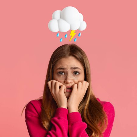 Photo for Scared angry sad young european female with abstract cloud of lightning and rain sign above head isolated on pink studio background. Bad mood, PMS, negative human emotion and facial expression - Royalty Free Image