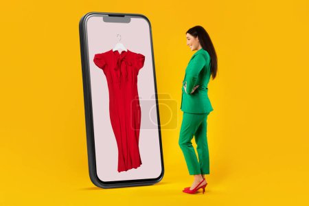 Photo for Collage of stylish woman looking at cellphone display with elegant dress, choosing new outfit, standing on yellow studio background. Online shopping concept - Royalty Free Image