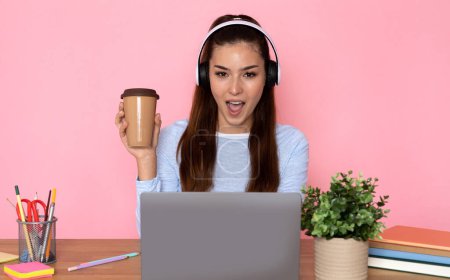 Photo for Energetic young business woman using technology laptop and headphone for working, video conference call, startups and business owner, social distance and self responsibility, pink background - Royalty Free Image