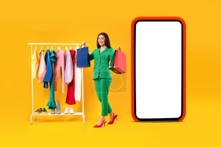 Photo for Mobile shopping. Happy lady standing with shopper bags near huge cellphone, choosing clothes on rail and buying online on yellow background. E-commerce concept. Collage - Royalty Free Image