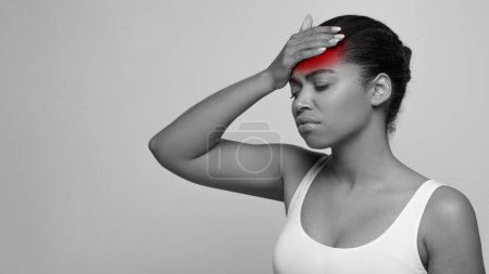 Photo for Black and white photo of sad young beautiful african american woman in pain touching forehead, have headache, suffering from migraine during period, studio background. Woman health concept - Royalty Free Image