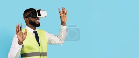 Photo for Amazed Black Male Construction Engineer Wearing VR Glasses Over Blue Background, Excited African American Builder Man Enjoying Virtual Reality Experience And Modern Technologies, Copy Space - Royalty Free Image