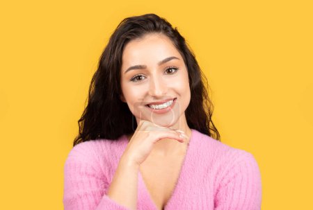 Photo for Cheerful millennial arab female in casual looking at camera isolated on yellow background, studio, close up. Beauty care, ad and offer, lifestyle, work and study, video call - Royalty Free Image