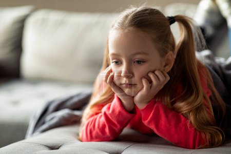 Photo for Pensive Upset Little Girl Relaxing On Couch At Home, Closeup Shot Of Thoughtful Sad Preteen Female Child Lying On Sofa In Living Room, Feeling Depressed And Lonely, Closeup Shot With Copy Space - Royalty Free Image