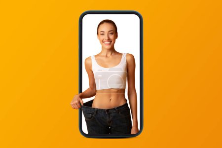 Photo for Smiling young european woman in sportswear enjoy weight loss result on smartphone screen, isolated on orange studio background, collage. App for sports, weight loss, fitness and blog - Royalty Free Image