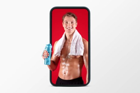 Photo for Glad millennial european muscular sweaty guy with naked torso with towel and bottle of water on phone screen isolated on white studio background. Body care app, sport blog and workout - Royalty Free Image