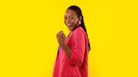 Photo for Joy Of Success. Glad African American Woman Gesturing Yes With One Hand Smiling At Camera Standing Over Yellow Studio Background. I Did It, Victory And Achievement Concept. Panorama - Royalty Free Image