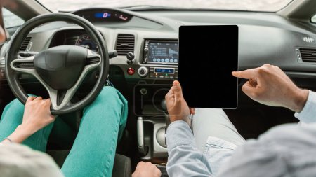 Photo for Car Navigation. Closeup Shot Of Couple Using Digital Tablet With Blank Screen Navigating Automobile. Driver And Passenger Browsing Short Routes And Trip Destinations Online. Panorama, Cropped - Royalty Free Image