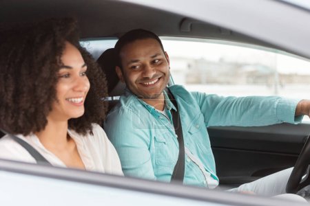 Photo for Owning A Car. Happy Middle Eastern Couple Driving Enjoying Journey By Vehicle, Man Driver Smiling To His Wife Traveling By New Automobile Sitting Inside. Rent And Leasing Offer. Selective Focus - Royalty Free Image