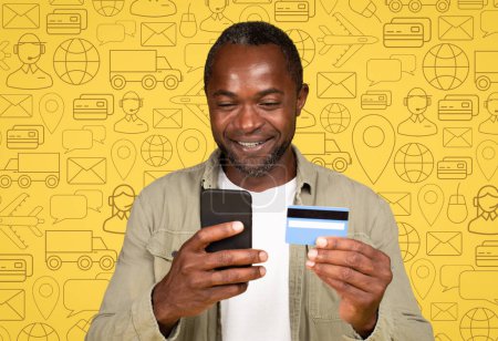 Photo for Smiling middle aged black man with phone and bank card in his hands over diverse digital world icons background. Concept of modern technologies, money transfer, banking, online payments, mobile app - Royalty Free Image