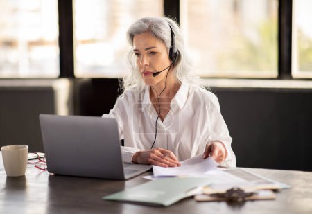 Photo for Customer Support. Hotline Operator Lady Wearing Headset And Making Video Call On Laptop, Providing Clients Assistance And Service Sitting In Modern Office Indoor. Corporate Business Communication - Royalty Free Image