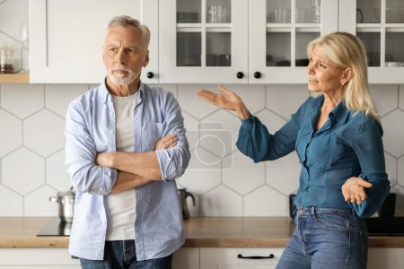 Domestic Conflicts. Portrait Of Senior Couple Arguing In Kitchen Interior, Angry Mature Lady Shouting At Her Husband At Home, Elderly Spouses Suffering Misunderstanding And Marital Crisis, Closeup