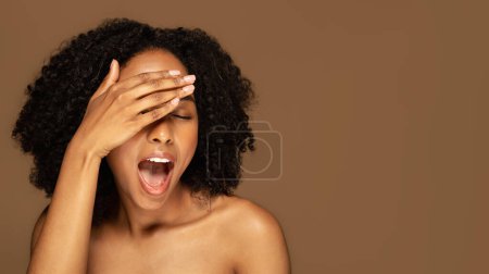 Photo for Exclusive spa deal, hot offer. Attractive emotional half-naked african american millennial woman covering her closed eyes with palm and exclaiming, isolated on brown background, copy space - Royalty Free Image