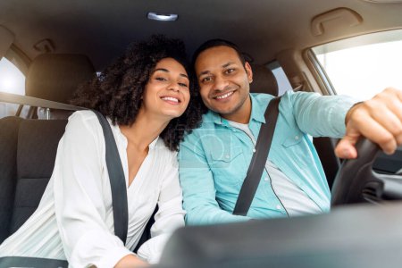 Photo for Car Owners. Happy middle eastern family husband and wife enjoying automobile ride together on weekend, leaning to each other posing with safety belts on, smiling at camera - Royalty Free Image