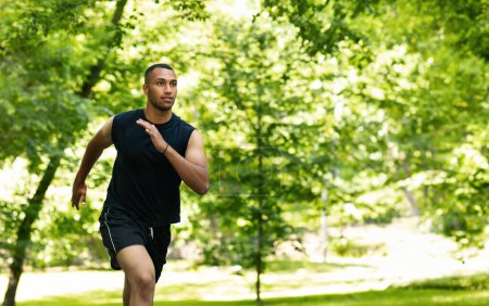 Photo for Serious attractive millennial african american man athlete sprinter training, running at summer park. Workout, sports outdoor, cardio exercises, prepare to competition and lifestyle - Royalty Free Image