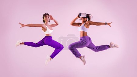 Photo for Virtual fitness game. Young black woman working out with 3D technology, jumping mid air as metaverse avatar wearing vr headset, purple studio background, full length - Royalty Free Image