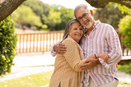 Photo for Satisfied smiling old european husband hugging wife, enjoy love, walk together in park, outdoor, copy space. Family romantic date, lifestyle and weekends, free time at summer, relationships - Royalty Free Image